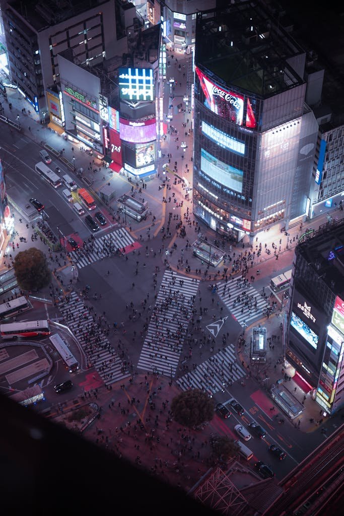 Aerial view of bustling Shibuya Crossing at night in Tokyo, Japan.